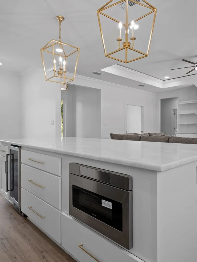 Custom kitchen island with gold pendants